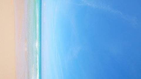 Vertical footage. Phuket beach Thailand. Beautiful tropical beach with blue sky and clouds. Tropical beach with waves crashing empty beach. Andaman  Sea sand and sky on beautiful summer day holiday