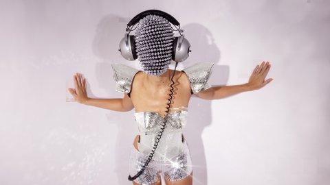 Mrs disco woman with a shiny mirror effect face wearing headphones and silver discoball top with overlayed glitch