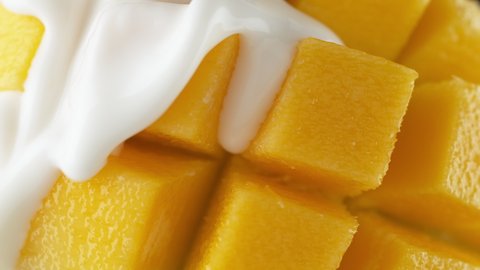 Pouring Yogurt over Sliced and Diced (Hedgehog) Mango Fruit in Slow Motion 1000fps