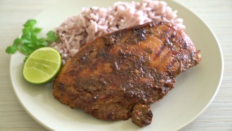 spicy grilled Jamaican jerk chicken with rice - Jamaican food style
