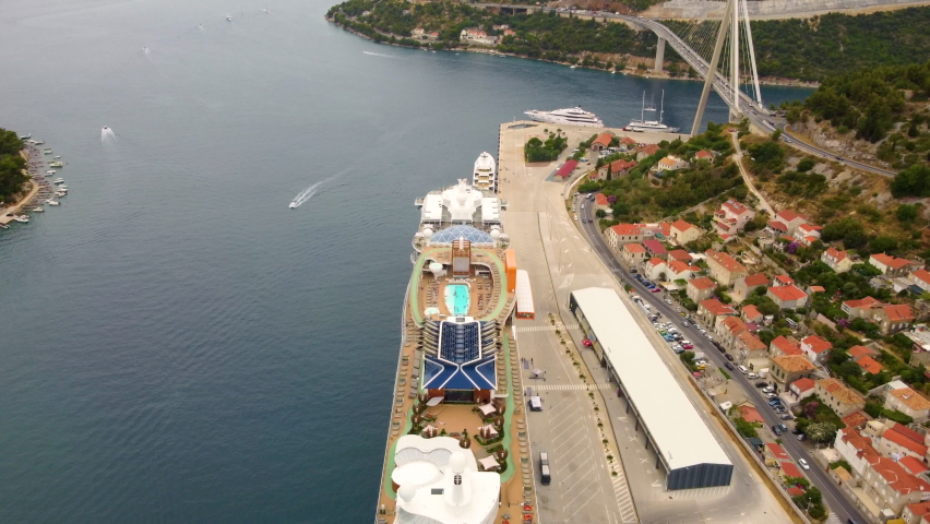 People Swim On Swimming Pool At Deck Of Cruise Ship Docked In The Port of Dubrovnik, Croatia. - aerial