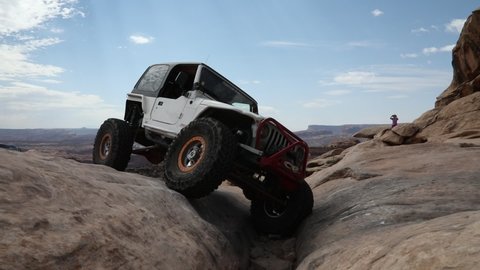 Moab, Utah,USA,,September 17,2021 : White Jeep Rubicon on the Golden Spike off road Jeep trail doing the Golden Crack obstacle.