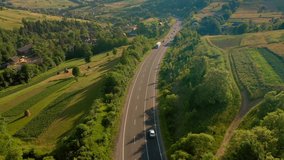 Majestic view from a drone flying over a road passing through a mountain pass. Carpathian mountains, Ukraine, Europe. Cinematic aerial shot. Explore the beauty of world. Filmed in 4k, drone video.