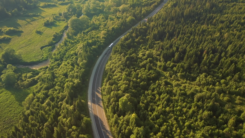 Shooting of a winding road passing through the wood from a bird's eye view. Location Carpathian mountains, Ukraine, Europe. Cinematic aerial shot. Explore the beauty of world. Filmed 4k, drone video. Royalty-Free Stock Footage #1080656216
