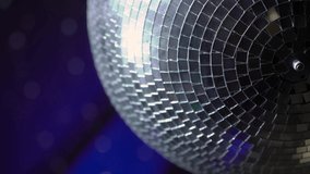 The disco ball is spinning at the party. Light effects of the starry sky, reflections in a mirror ball. Stage light in a nightclub or concert. Blue and white. - Powered by Shutterstock - Get 15% off with code: PIKWIZARD15
