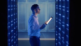 IT technician in data center digital server room controlling work of rack server cabinets with a tablet. Professional server engineer at work. - Powered by Shutterstock - Get 15% off with code: PIKWIZARD15