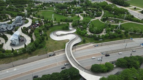 Chicago USA. Aerial View of Maggie Daley Park and BP Pedestrian Bridge, Columbus Drive Traffic on Cloudy Summer Day