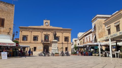 Favignana , Italy - 09 05 2021: Unique low angle view of Town Hall in Piazza Europa square on Favignana island in Sicily