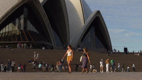SYDNEY, NSW, AUSTRALIA. MARCH 06 2020. Tourists in the sun at Sydney Opera House, slow motion.