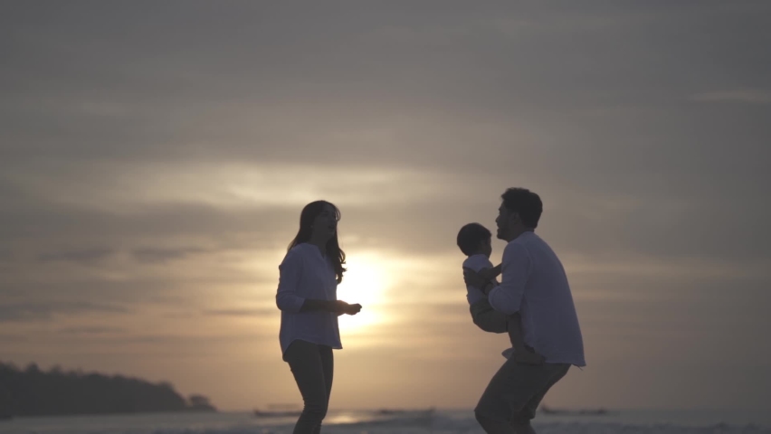 Portrait of Asian Indonesian Happy Family Father Mother and Child Spending Time Together at The Beach during Sunset - Relationship, Bond, Parenting, Laugh and Love | Shutterstock HD Video #1080669413