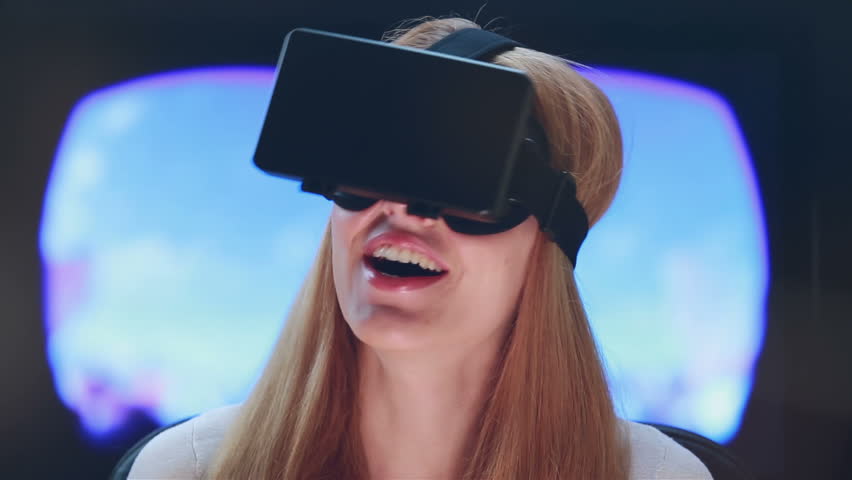 Virtual reality game. Girl with pleasure uses head-mounted display. Royalty-Free Stock Footage #10806869