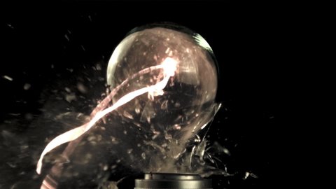 Super slow motion light bulb explodes with shards of glass. On a black background. Filmed on a high-speed camera at 1000 fps.