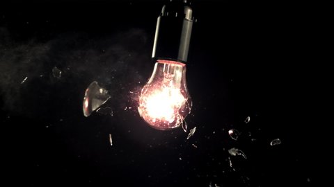 Super slow motion light bulb breaks into rattles. On a black background. Filmed on a high-speed camera at 1000 fps.High quality FullHD footage