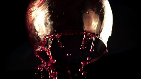 Super slow motion from the glass dripping red wine. On a black background.Filmed on a high-speed camera at 1000 fps. High quality FullHD footage