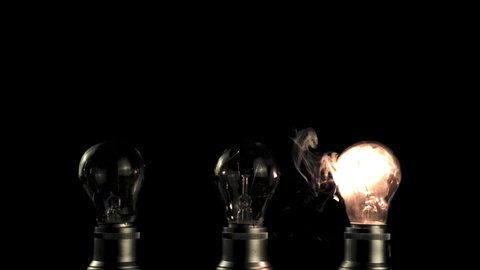 Super slow motion three light bulbs explode. On a black background.Filmed on a high-speed camera at 1000 fps.