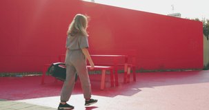 Cool child teen girl dancing fiery outside with wireless speaker in sunshine on street. Dance school advertisement video