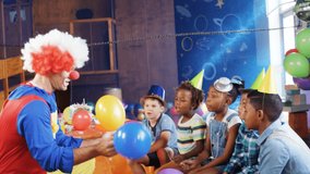 Animation of confetti falling over clown playing with balloons at children's party. childhood, party, entertainment and celebration concept digitally generated video.