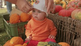 Toddler with vegetables. Baby play with pumpkin at farmers market, mothers hands panama on head. Seasonal fruits and vegetables diverse food options supporting local farmers promoting small businesses - Powered by Shutterstock - Get 15% off with code: PIKWIZARD15