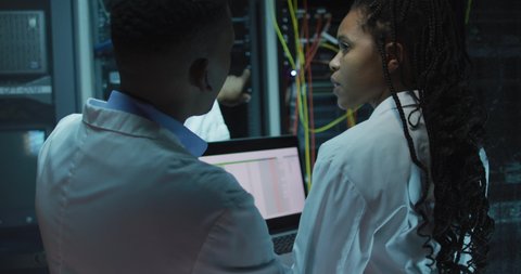 African american computer technicians using tablet working in business server room. digital information storage and communication network technology.