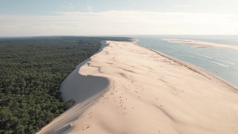 Aerial cinematic view of Dune du Pilat in France during day. Drone fly forwards. Dune du Pilat is the biggest sand dune in Europe