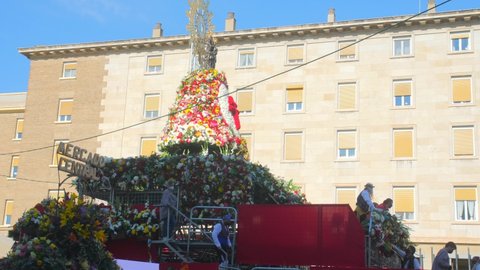 Zaragoza , Spain - 10 11 2021: Annual Celebration of Fiestas del Pilar With Patron Saint And Flowers On A Huge Platform