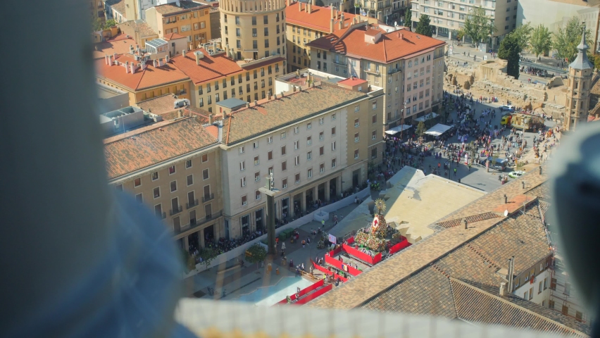 Hundreds Of People Offering Flowers At The Statue Of The Virgin Mary On Platform At Plaza del Pilar During Fiestas del Pilar In Zaragoza, Aragon, Spain. - aerial