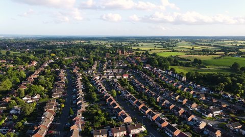 Ariel view of Kenilworth town in Warwickshire. residential area and historic Kenilworth castle in background.