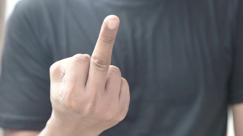 close up of middle finger gesture as a sign of fuck