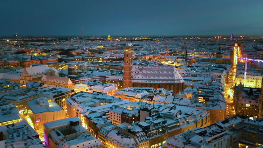 Munich aerial skyline view at night with snow winter time christmas, fly over marienplatz sqaure frauenkirche church and town hall, munich night drone video birds view. Germany munich city. Royalty-Free Stock Footage #1080728543