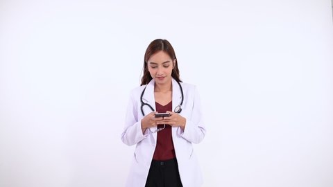 female doctor wearing a white uniform is shocked while making a phone call