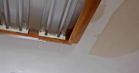Ceiling kitchen in damage caused by a leaking water pipe a water drops on the ceiling