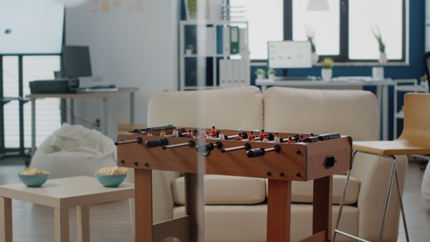 Close up of foosball table to play football game in empty office. Table used for soccer game after work in space to celebrate party with drinks and entertainment. Workplace to have fun.