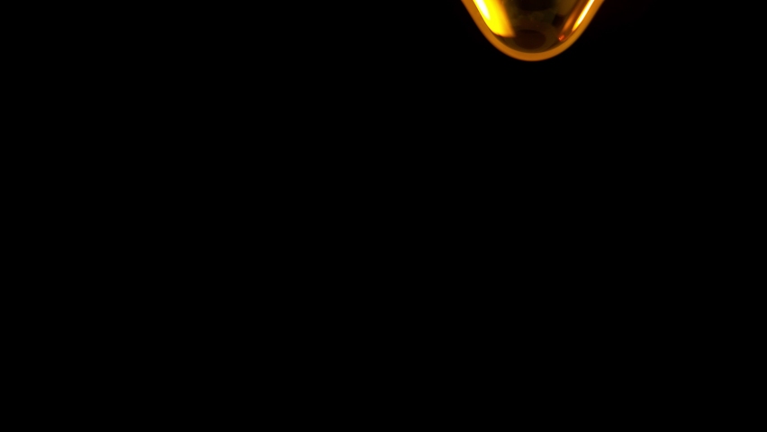 Super Slow Motion Shot of Falling Golden Droplets Isolated on Black Background at 1000 fps. Royalty-Free Stock Footage #1080742766