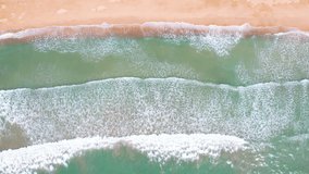 4K Video.Top view empty sea waves and sky on sand popular beach.waves breaking to sand for long beach sunset.Fantastic nature seascape wave texture splash beach summer island.no people. Space