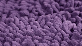 Close-up view 4k video footage of purple fluffy texture of mop of household cleaning tools