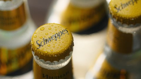 WARSAW, POLAND - SEPTEMBER 10, 2021: drop of water drops to the cap of cold bottle of the schweppes tonic, Full HD Prores HQ
