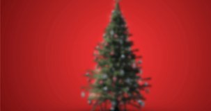 Animation of snow falling over christmas tree on red background. christmas, tradition and celebration concept digitally generated video.