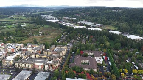 Cinematic panning 4K aerial drone footage of Valley Industrial and downtown, Town Center of Woodinville, an upscale, affluent Seattle neighborhood near Bothell in King County, Washington