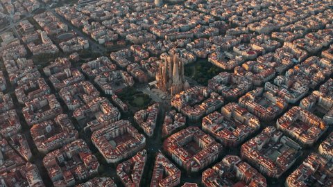 High circling drone shot of La Sagrada Familia Church Barcelona at sunrise