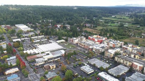 Cinematic 4K aerial dolly out drone footage of Valley Industrial and downtown, Town Center of Woodinville, an upscale, affluent Seattle neighborhood near Bothell in King County, Washington