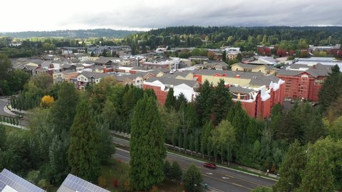 Cinematic 4K aerial rise and reveal drone footage of downtown, Town Center of Woodinville, an upscale, affluent Seattle neighborhood near Bothell in King County, Washington