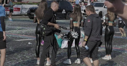 belarus,minsk,2021. cheerleaders dressed in black leather pants greet the runners at the finish of the marathon