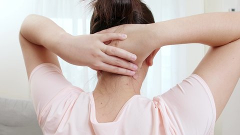 Close up of tired woman massaging rubbing stiff sore neck tensed muscles fatigued from work in incorrect posture feeling hurt joint shoulder back pain ache close up rearview. Healthcare concept