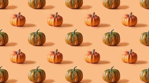 Slow motion of seamless pattern with Halloween Pumpkins and Thanksgiving Day on orange background. Autumn harvest and shopping. Sale. 4k video. स्टॉक वीडियो