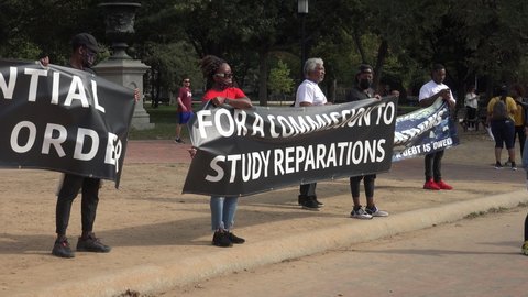 WASHINGTON, DC - OCT. 16, 2021: Activists demonstrate at White house demanding Pres. Biden sign an executive order to study reparations, and establish a commission for descendants of American slavery.