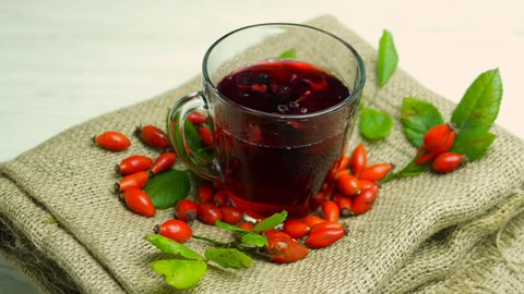 Natural tea made from red rosehip berries, homeopathy herbal tincture of berries. Fruit red tea