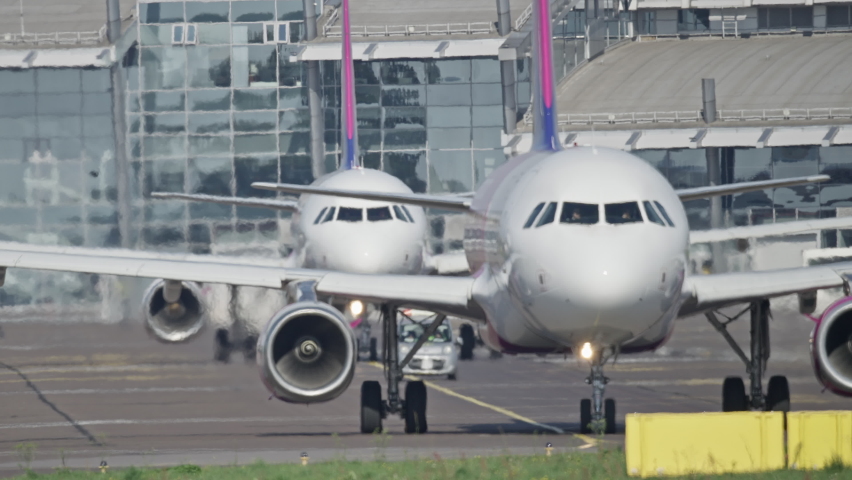 Planes are waiting in line to leave for the airport runway. Video of the life of a crowded airport. | Shutterstock HD Video #1080815576