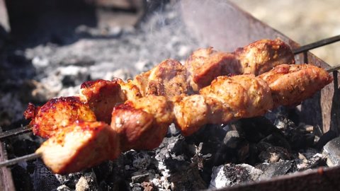 Barbecue Grilled pork kebabs meat lamb kebab marinated barbecue meat shashlik shish kebab outdoors picnic. Shashlik or Shish kebab popular in Eastern Europe and Russia. Slow motion. Selective focus