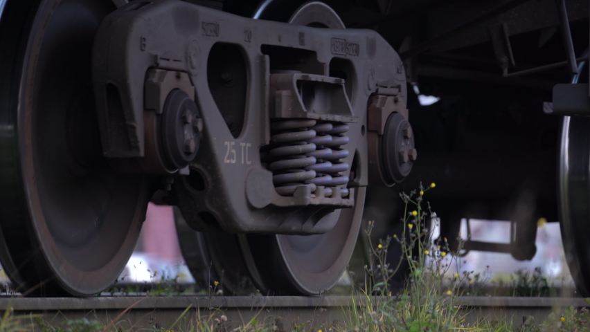 Cargo train rides on railroad moving slowly by rail at the station. Closeup of wheels on railway. Close up of wheeled pair of freight railway train. Transport concept.  Royalty-Free Stock Footage #1080827381
