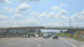 texture blur and defocus, highway, cars and freight transport, roadside and asphalt, green forest and blue sky on a summer day 